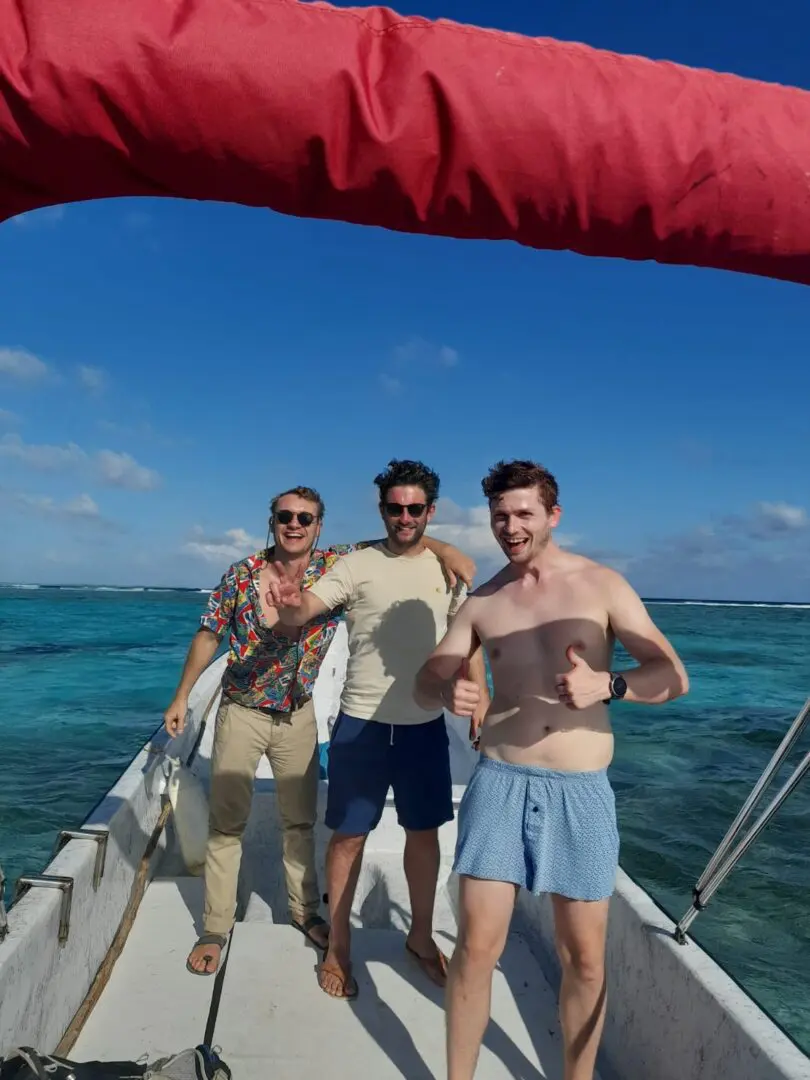 Three people on a boat in the ocean.