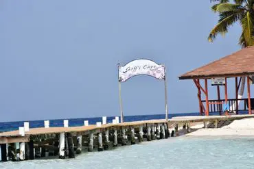 A beach with a pier and a sign on it